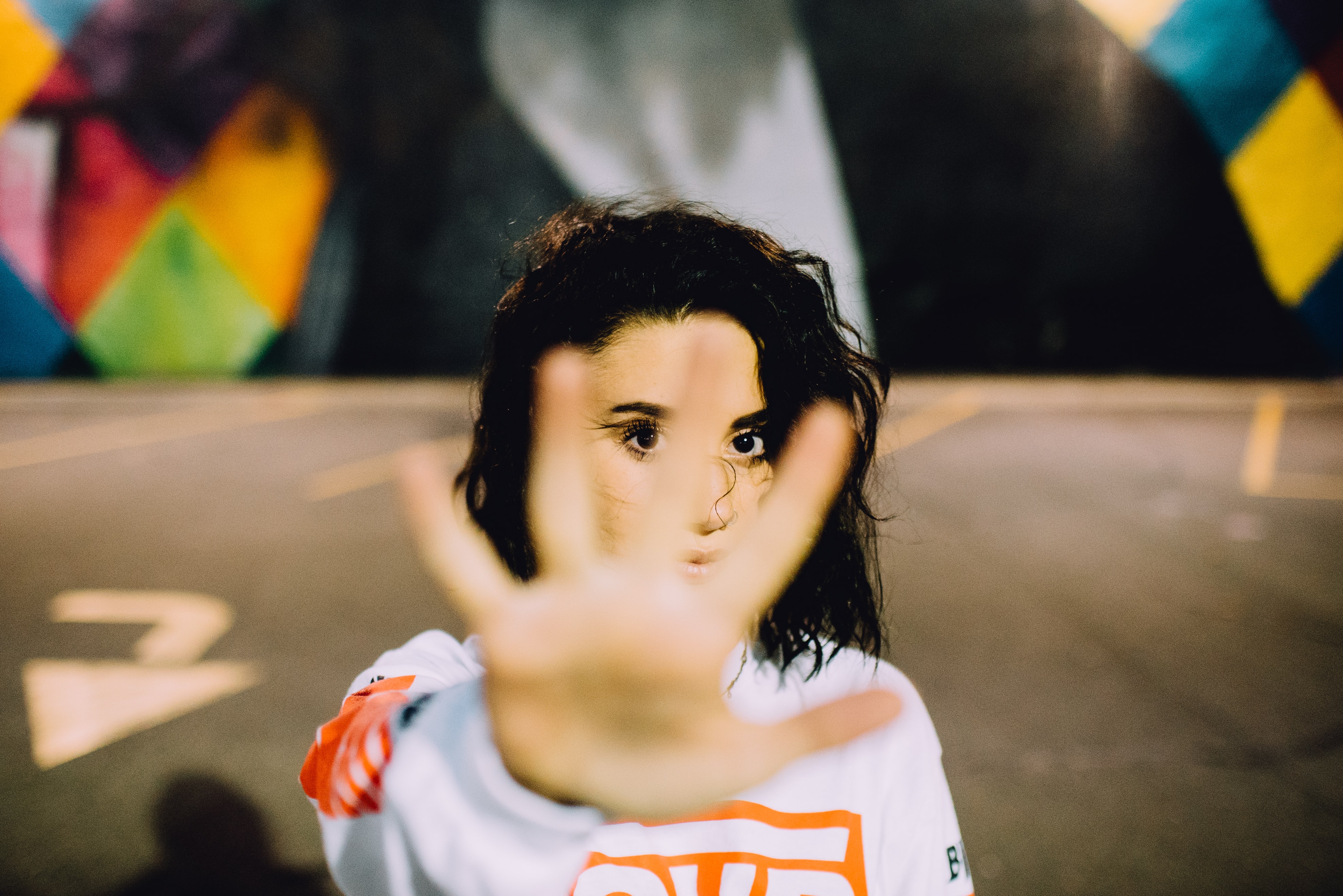 Woman with her hand obscuring her face