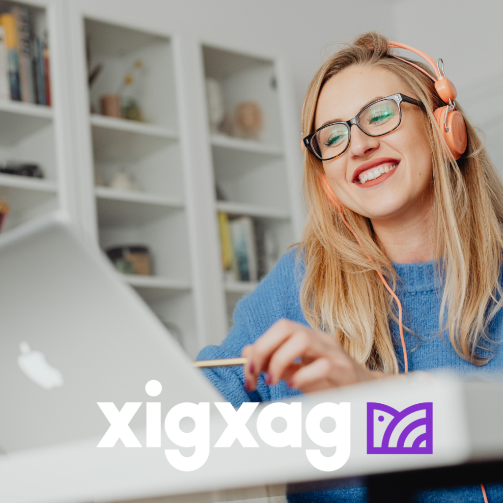 Female listening on headphones and looking at laptop