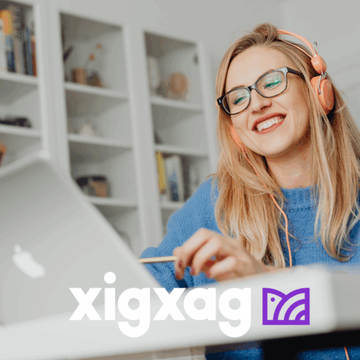 Female listening on headphones and looking at laptop